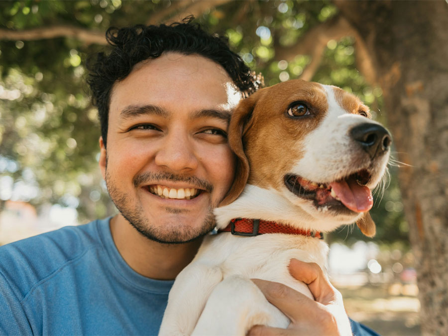 Smiling man with beagle dog.