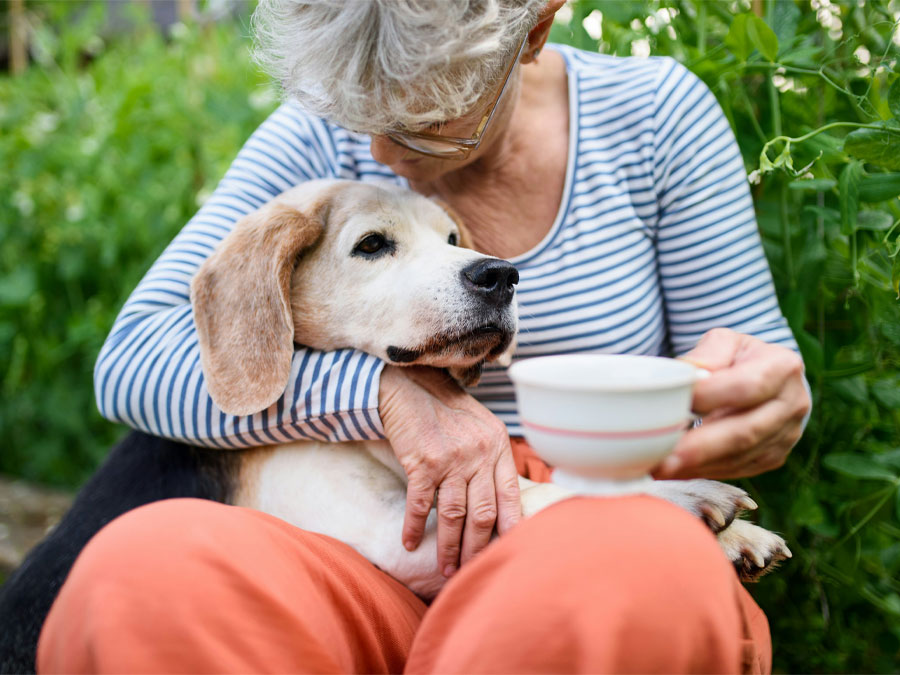 Elderly woman hugging her dog.